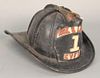 Leather firefighter's helmet having brass finial marked FD and front plaque stating Hook and Ladder #1 GVFD, possibly Gilford Volunt...
