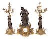 * A French Three-Piece Figural Clock Garniture Height of first 28 1/2 inches.