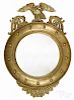 Giltwood convex mirror, early 20th c., with an eagle crest, 37'' h.