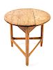 An English Pine Cricket Table Height 30 x diameter 29 inches.