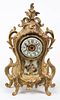A Louis XVI Style Porcelain Inset Mantel Clock Height 11 1/4 inches.