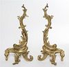 A Pair of Louis XV Style Brass Chenets Height 18 1/2 inches.