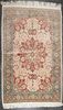 A Persian Wool and Silk Rug 5 feet 10 inches x 3 feet 10 inches.