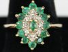 10k y.g. ladies ring having marquis form setting with center small emerald having 8 small round cut