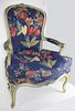 Louis XV style carved upholstered arm chair in blue and white paint. Early 20th c.