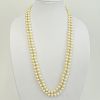 Long Vintage Double Strand White Pearl Necklace with 14 Karat Yellow Gold Clasp with Small Diamond Accents.