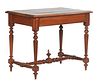 French Carved Walnut Henri II Style Writing Table, 19th c., the stepped top over a wide skirt, on turned tapered and block trestle supports, joined by