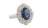 Lady's Platinum Dinner Ring, with a 3.66 carat oval blue sapphire atop a pierced border mounted with forty-two small round diamonds, total diamond wt.