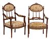 Pair of Louis XVI Style Carved Beech Fauteuils, 20th c., the pierced ribbon crest over an oval upholstered back on turned tapered vertical spindles, t