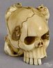 Japanese carved ivory netsuke, late 19th c., in the form of rats crawling around a human skull
