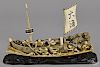 Japanese carved ivory boat, late 19th c., with men launching the boat from a shoreline, 17 1/4'' l.