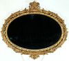 A MID 20TH CENTURY CARVED AND GILDED WOOD MIRROR.