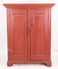 An American country red painted two door cupboard