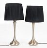 A pair brushed aluminum 'Orient' style table lamps