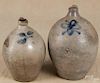 Two ovoid stoneware jugs, 19th c., with cobalt floral decoration, 14'' h. and 11 1/2'' h.