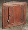 Pennsylvania painted pine hanging corner cupboard, 19th c., retaining an old red surface, 23 1/2'' h.