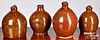 Four graduated redware jugs, 19th c.