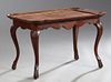 Carved Walnut Coffee Table, c. 1930, the serpentin