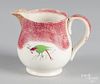 Red spatter creamer with parrot decoration, 4'' h.