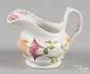 Yellow and red rainbow spatter creamer with thistle decoration, 4 1/4'' h.