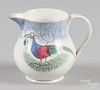 Blue spatter creamer with teal peafowl decoration, 4 1/8'' h.