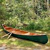 Arthur E. Levenseller 20-foot Canoe with Two Canoe Paddles.