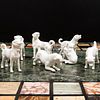 Group of Seven White Glazed Porcelain Models of Puppies