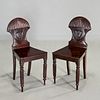 Pair George V carved mahogany hall chairs