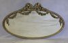 Antique Giltwood and Gessoed Oval Ribbon Mirror.