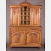 A French Carved Walnut Buffet a Deux Corps in the French Provincial Style, 19th/20th Century.