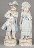 Pair of bisque figures of a boy and girl in blue, 15'' h.