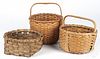 Three split oak baskets, largest - 10 1/2'' h., 9'' w.