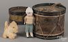 Two stenciled tin drums, largest - 7 1/4'' h., 9'' w., together with a chalk doll and a stuffed dog.