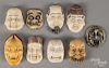Nine Japanese carved ivory and composition mask netsukes.