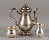 Sterling silver teapot, together with a matched creamer and sugar, 30.2 ozt.