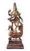 An Indian Polychrome Wood Figure of a Dancing Deity Height 35 1/4 inches.