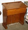 Early pine lift top school master's desk, paneled back. 33"w x 37"h.