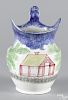 Blue spatter pitcher with schoolhouse decoration, 9 3/8'' h.