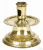 Brass capstan candlestick, 17th c., with a scalloped drip pan and punched decoration, 4 1/2'' h.