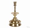 Outstanding English brass candlestick, mid 16th c., with a round incised cup