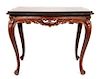 * A Louis XV Style Carved Occasional Table Height 23 1/2 x width 29 1/2 x depth 19 1/4 inches.
