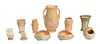 Group of Ten Pieces of Weller Pottery, consisting of a cylindrical basket, two triangular low bowls, a low candlestick, a cylindrical floral relief ha
