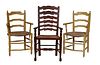 Group of Three French Provincial Rushseat Ladderback Armchairs, early 20th c., two in polychromed yellow, with bowed seats and turned legs; together w