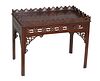 English Carved Mahogany Chippendale Style Coffee Table, 20th c., with a pierced gallery on all sides, over a pierced skirt, on square legs with pierce