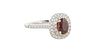 Lady's 18K White Gold Dinner Ring, with an oval prong set 1.18 carat orange sapphire atop a double graduated concentric border of tiny white diamonds,
