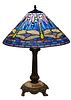 Contemporary Tiffany Style Dragonfly Leaded Glass Lamp, 20th c., the blue and lavender shade with circular cabochon jewels, on a patinated spelter twi