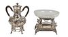 Two Pieces of Silverplate, early 20th c., consisting of a repousse hot water urn, with grape and leaf decoration and ebonized wood; together with a la