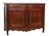French Provincial Louis XV Style Carved Walnut Sideboard, 19th c., the canted corner three board top over two wide frieze drawers, above double cupboa