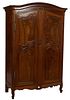 Diminutive French Provincial Carved Walnut Louis XV Style Armoire, 19th c., the stepped arched crown over double three panel doors with iron escutcheo