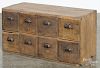 Pine country store drawered cupboard, 19th c., having two rows of four drawers, 18'' h., 35'' w.